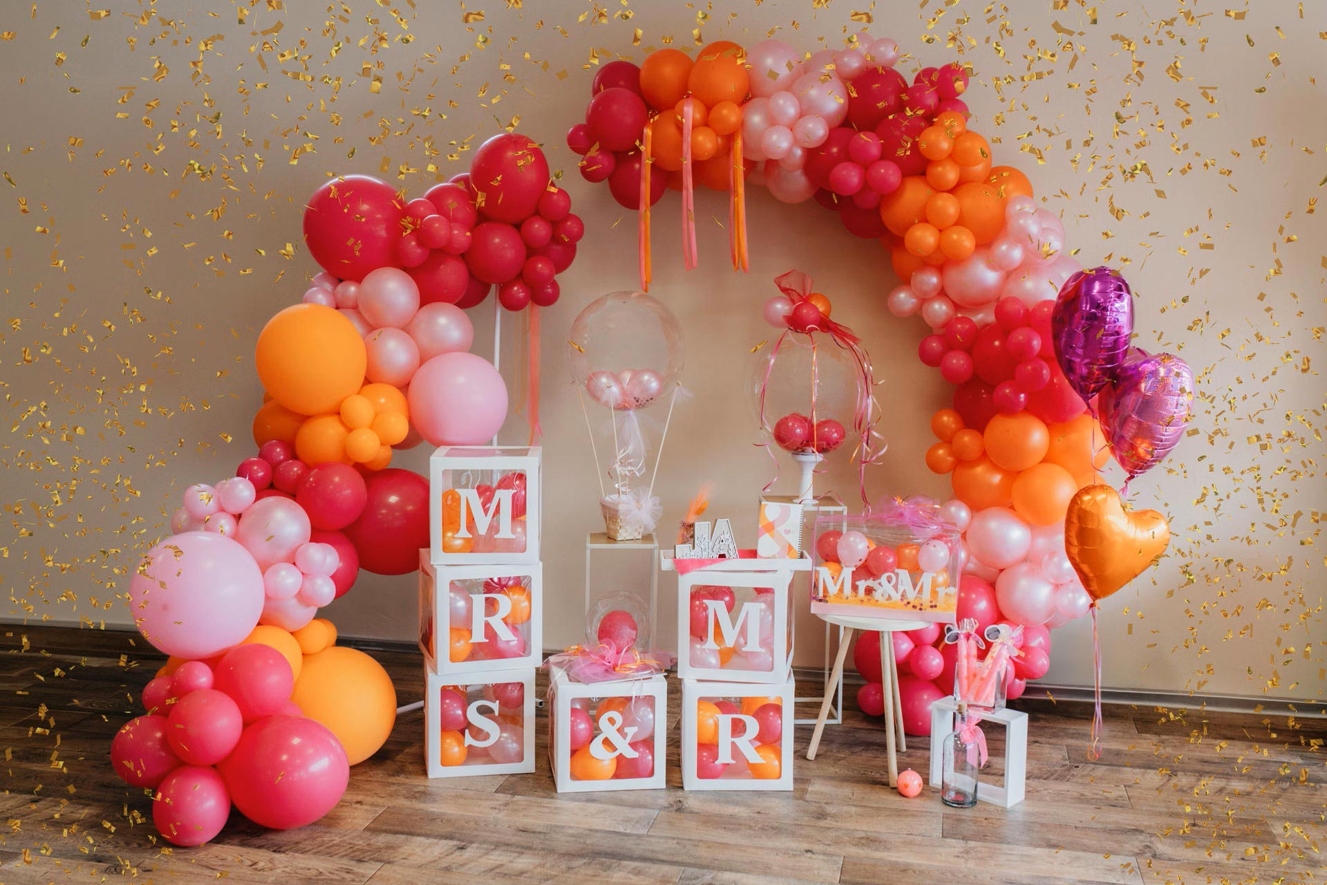 Eine bunte Ballongirlande mit roten, orangen und pinken Luftballons und Dekoration